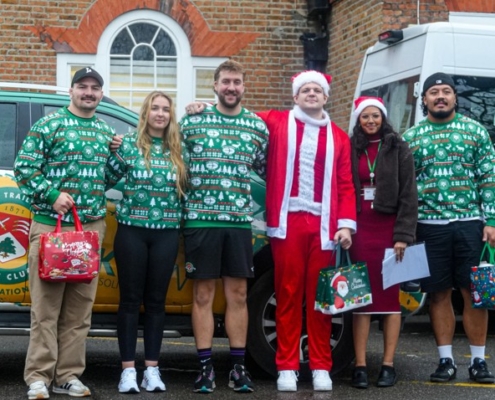 Ealing Trailfinders players delivering Christmas hampers with Age UK Ealing